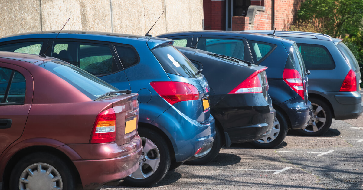 Row of cars parked forwards in bays