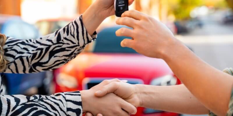 Hands shaking exchanging car keys