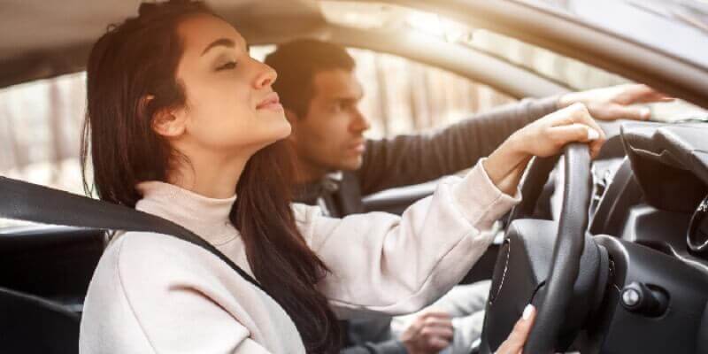 Girl and man looking over dashboard in the car